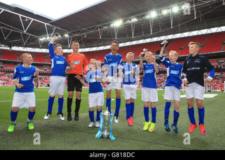 Oldham Athletic represented by South Failsworth Primary school jump for joy in celebration after winning the Kinder+Sport Kids Cup Final. Stock Photo