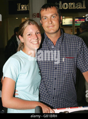 Honeymoon couple Charlotte and Marcus Walsh from Manchester arrive back at Gatwick Airport. Passengers on a Phuket Air Boeing 747 halted the planes take-off yesterday morning at Sharjah International Airport in the United Arab Emirates, after a refuelling stop on the journey from Bangkok to London, when they spotted fuel spewing over the wing of the jet. Stock Photo