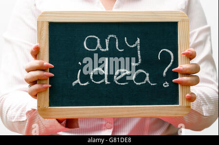 Young women holding blackboard, words written with white chalk Stock Photo