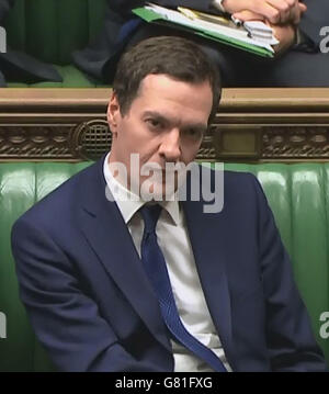 Chancellor George Osborne looks on as Labour backbencher Ed Miliband speaks in the House of Commons, London, during a debate on the Queen's speech. Stock Photo