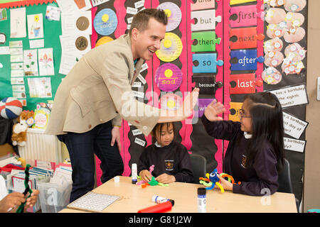 (Left to right) Chloe Tabil and Kelly Dizon at a pompom bugs arts and crafts day hosted by Mr Pritt, the mascot for Pritt Stick, and CBeebies' Mister Maker at Sacred Heart Roman Catholic School in Battersea, London, after the school won the exclusive crafting day as part of a competition run by the glue brand Pritt. Stock Photo