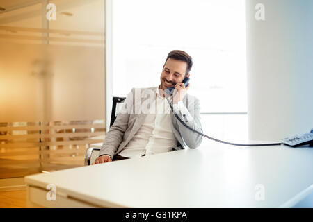 Businessman using talking on phone in  modern office Stock Photo