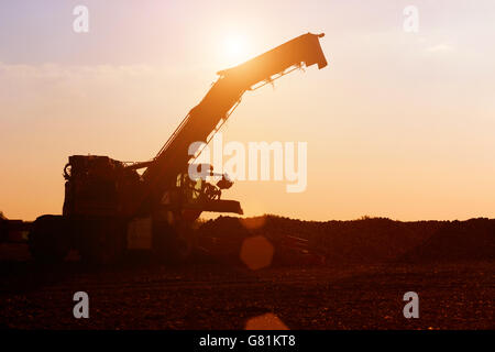 Agricultural machinery in the sunset Stock Photo