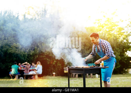 Barbecue in nature being done by friends Stock Photo