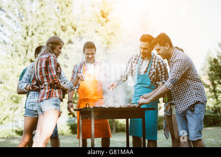 Young people enjoying barbecuing Stock Photo