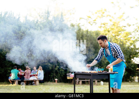 Barbecue in nature being done by friends Stock Photo