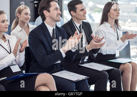 Happy business group of people clapping hands during a meeting conference Stock Photo