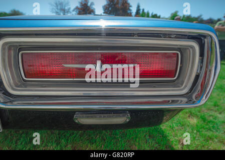 Detail of the rear light of a blue 1960s Ford Thunderbird car. Stock Photo