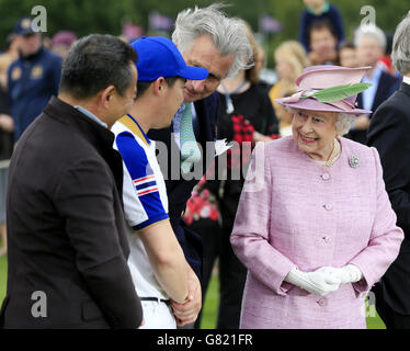 Queen Elizabeth II talks to members of the King Power Foxes polo team at the Cartier Queen's Cup polo tournament final at Guards Polo in Windsor Great Park, Berkshire. Picture date: Sunday June 14, 2015. See PA story ROYAL Polo. Photo credit should read: Jonathan Brady/PA Wire Stock Photo