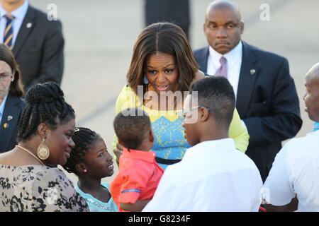 US first lady Michelle Obama greets a child as she arrives at Stansted Airport, Essex, for a visit to the UK, to promote her campaigns for girls' education and better support for military families. Stock Photo
