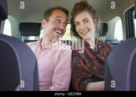 Cheerful couple sitting in car Stock Photo
