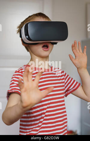 Boy using virtual reality simulator at home Stock Photo