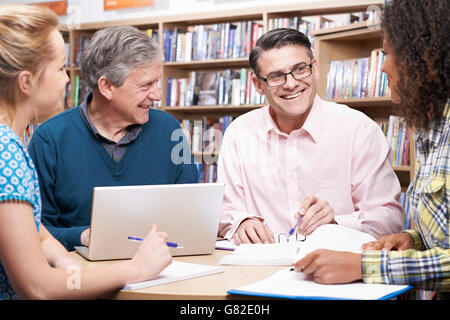 Group Of Mature Students Studying In Library Stock Photo