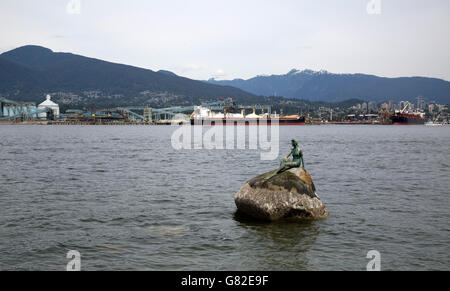 Bronze sculpture of 'Girl in Wetsuit' on large boulder off the north shore of Stanley Park in Vancouver,British Stock Photo