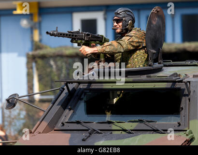 BURG / GERMANY - JUNE 25, 2016: german soldier secures with machine gun a zone on open day in barrack burg / germany at june 25, Stock Photo