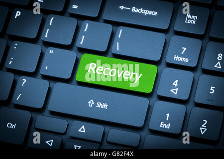 Close-up laptop keyboard. The focus on the Recovery key. Toning is blue. Stock Photo