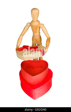 Wooden mannequin opens heart shaped gift box Stock Photo