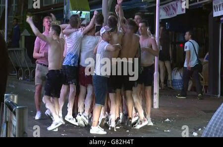 Screen grab taken from PA Video of tourists on the Punta Ballena strip in Magaluf, Spain, as the town saw tough new rules cracking down on drunkenness come into force at midnight - but the resort still witnessed the debauched scenes that have made it infamous. Stock Photo