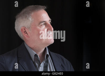 Author, illustrator and political cartoonist Chris Riddell poses for a photograph after he was unveiled as the new Waterstones Children's Laureate at a ceremony at BAFTA in London. Stock Photo
