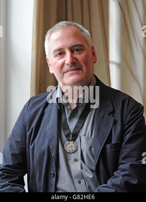 Author, illustrator and political cartoonist Chris Riddell poses for a photograph after he was unveiled as the new Waterstones Children's Laureate at a ceremony at BAFTA in London. Stock Photo