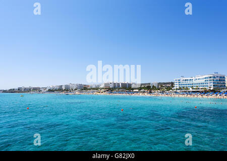 PROTARAS, CYPRUS - JUNE 12, 2016:Photo of sea and fig tree bay beach in protaras, cyprus island with swimming people and hotels. Stock Photo