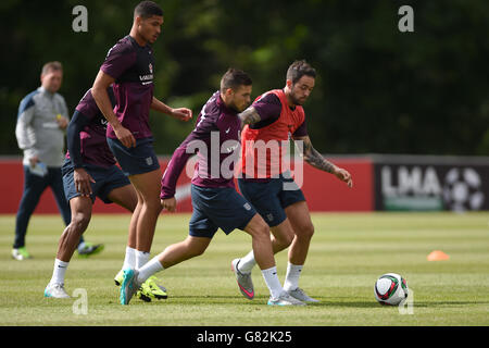 England's Danny Ings (right) is tackled by Jake Forster-Caskey during a training session at St George's Park, Burton. Stock Photo