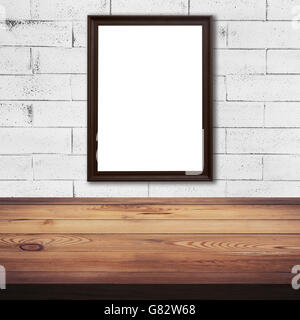 frame picture on white brick wall and wood table background texture with space Stock Photo