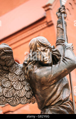 Close Up Of Statue Of Archangel Michael With Outstretched Wings, Thrusting Spear Into Dragon Before Catholic Church Of St. Simon Stock Photo