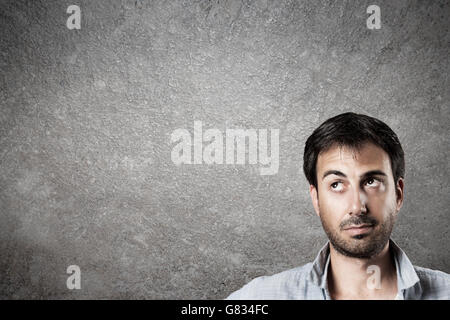 Man expectantly looking up with raised eyebrow. Horizontal image. Stock Photo