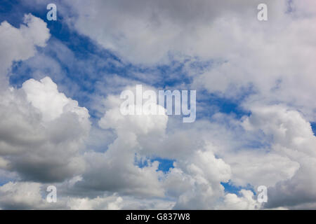 Natural abstract background of dramatic cloud formations in a blue summer sky. Stock Photo