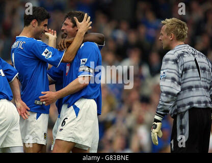 Portsmouth's Arjan de Zeeuw (C) celebrates scoring with Dejan Stefanovic as Southampton goalkeeper Antti Niemi looks on. Stock Photo