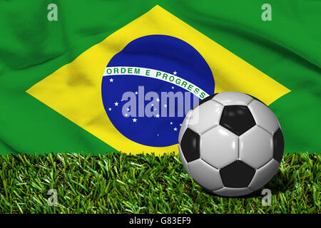 3D rendered soccer ball in grass field with Brazil flag as Background Stock Photo