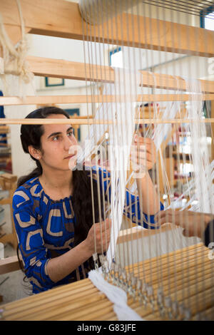 A student practices weaving at the Institute of Traditional Arts in Fez, Morocco. Stock Photo