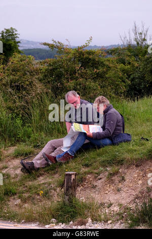 An older couple looking at a map out in the country. Stock Photo