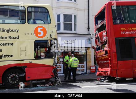 Police officers at the scene after two buses were involved in a crash in Brighton, East Sussex, which has left two people with life-threatening injuries and three others seriously hurt. Stock Photo