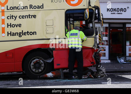 A police officer at the scene after two buses were involved in a crash in Brighton, East Sussex, which has left two people with life-threatening injuries and three others seriously hurt. Stock Photo