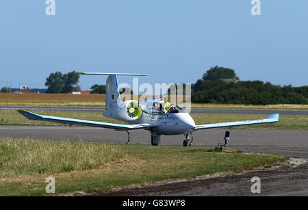 Pilot Didier Esteyne celebrates after landing the E-Fan electrically powered plane following his successful crossing of The Channel from Lydd Airport in Kent. Stock Photo