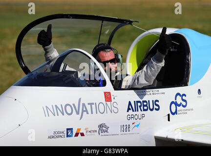 Pilot Didier Esteyne celebrates after landing the E-Fan electrically powered plane following his successful crossing of The Channel from Lydd Airport in Kent. Stock Photo