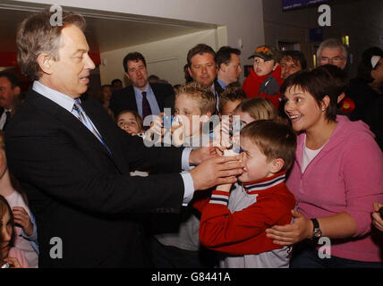 Britain's Prime Minister Tony Blair helps a schoolboy take a picture of him during a visit to a science and natural history education centre. Stock Photo