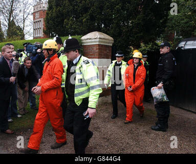 Greenpeace activists are led away by police after coming down from the roof of the home of John Prescott, the Deputy Prime Minister. A spokesman for Greenpeace said the group were attempting to install a solar panel on the roof of his constituency home in Hull in a bid to highlight the Government's record on energy. Stock Photo