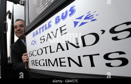 Scottish National Party leader Alex Salmond stands by his campaign battlebus, on the election trail in Livingston. Stock Photo