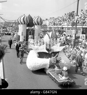 Customs and Traditions - Battle of the Flowers - Jersey. The parish of St Brelade present their Slave of the Lamp float during Jersey's Battle of the Flowers. Stock Photo