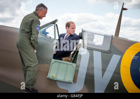 The managing director of the Aircraft Restoration Company (ARC) and pilot John Romain (left) talks to the Duke of Cambridge as he sits in a newly restored Supermarine Spitfire Mark I N3200 which was donated to the Imperial War Museum in Duxford by American philanthropist Thomas Kaplan. Stock Photo