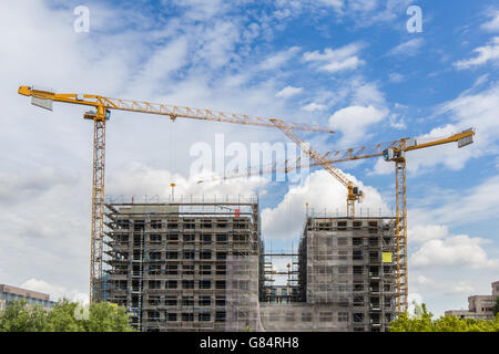 construction cranes at big building construction site Stock Photo