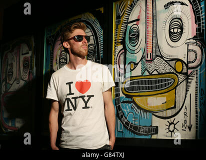 Artist Joachim poses next to some of his work, during a press preview of the Graffiti Street Underground Group Show 2015 - a new body of work by twelve graffiti and street artists within the urban art scene - at the old underground ticket hall in Shoreditch, London. Stock Photo