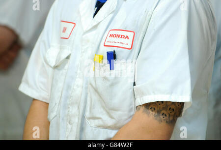 Detailed view of the overalls worn by a worker at Honda of the UK Manufacturing Ltd's factory in Swindon as he awaits the arrival off the production line of the new Civic Type R Stock Photo