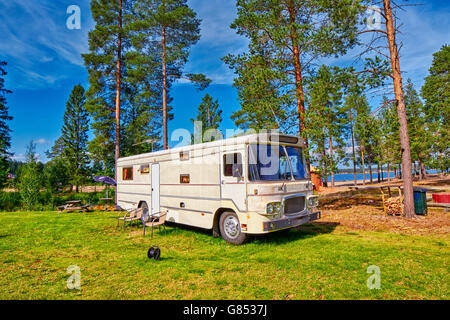 Big Old American RV / Camping Car in Pine Forest Setting Stock Photo