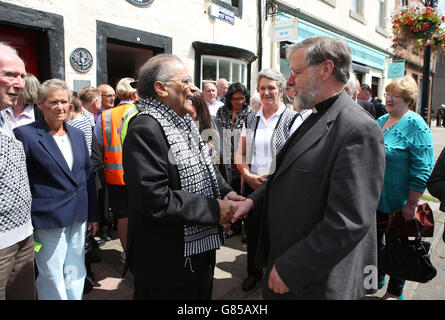 Manzoor Alam, 73, the new postmaster for the world's oldest post office, is congratulated by locals as he opens the Sanquhar Post Office in Dumfries and Galloway. Stock Photo