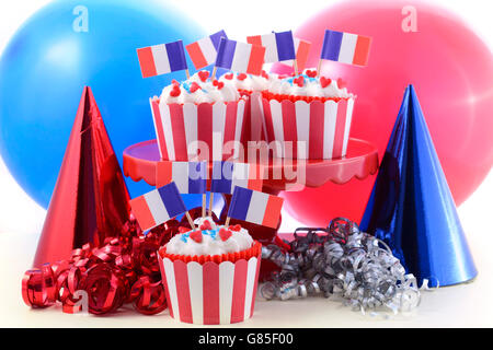 Happy Bastille Day cupcakes in bright red, white and blue party setting. Stock Photo