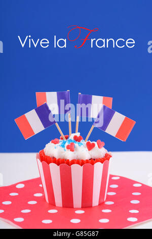 Happy Bastille Day cupcake with red, white and blue french flags. Stock Photo